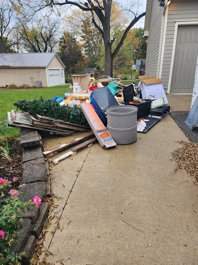 Dumpster being loaded with debris for Roofing Dumpster Rental in Mountain Home AFB